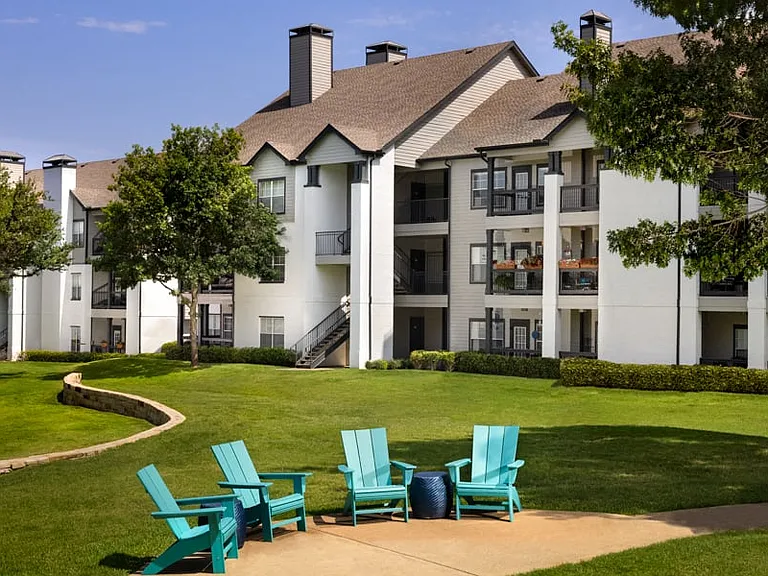Outdoor seating areas surrounded by lush landscaping