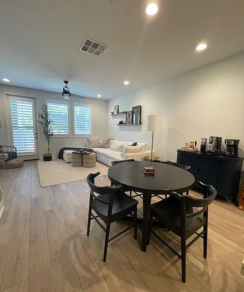 Open concept living with dining set in addition to bar seating.