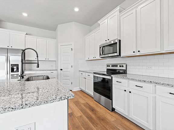 The kitchen has sprawling granite countertops.