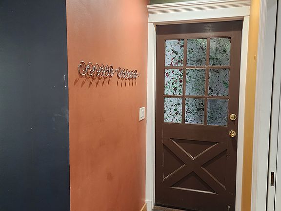 This is inside the apartment showing the front door and entry way. Just to the right is the living room with pocket double glass doors which are fully open and inside the wall in this picture. They can be fully closed with large glass see through doors.