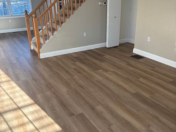 Living area with closet and view into dining room.