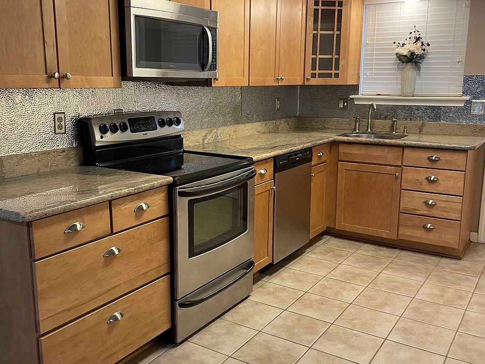 Kitchen, granite and stainless steel appliances.