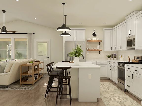 Kitchen with vaulted ceiling and pendant lighting