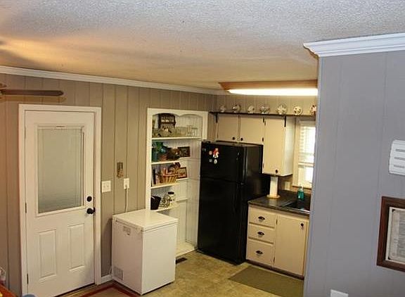 Kitchen and Door to Garage with Workshop Area