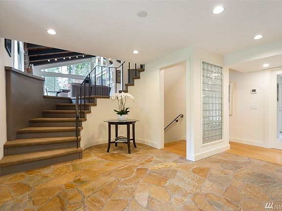 Welcoming foyer with original slate flooring embraces the mid century design, but opens onto the light filled living spaces of this fully updated home!  Besides the updated interior rooms, the home has a new roof which was installed in 2012, a new hot water heater which was installed in 2016,  plus a new heat pump, furnace, water pressure tank and full seismic retrofit in 2018!