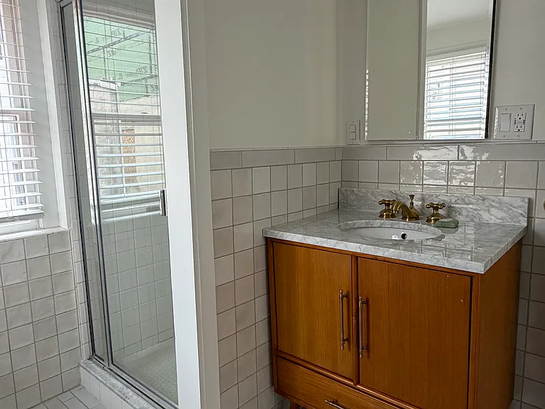 Medicine cabinet and vanity provide ample storage.
