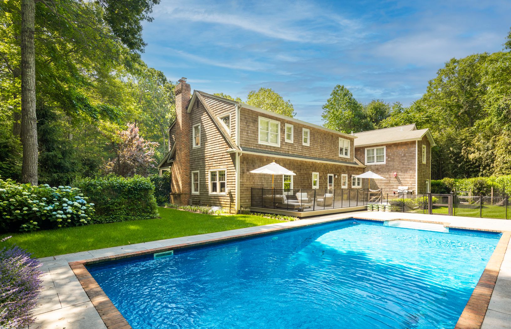  Rear yard featuring inviting deck and heated pool