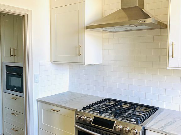 Stainless appliances including a gas stove.