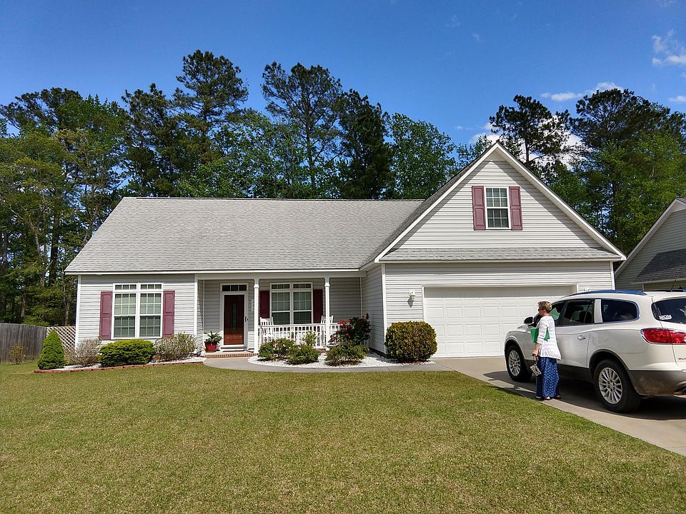 The front of the house. Both neighbors have privacy fences installed.