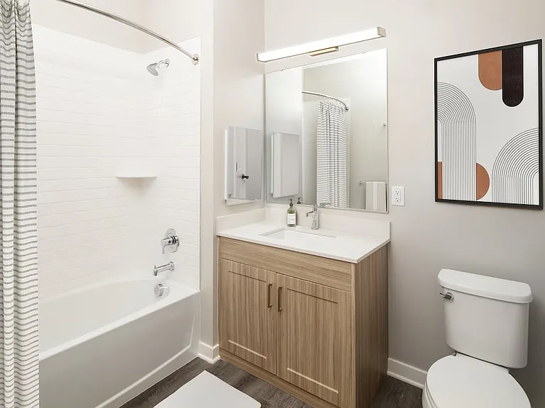 Signature Collection bath with quartz countertop, oak cabinetry, and hard-surface flooring