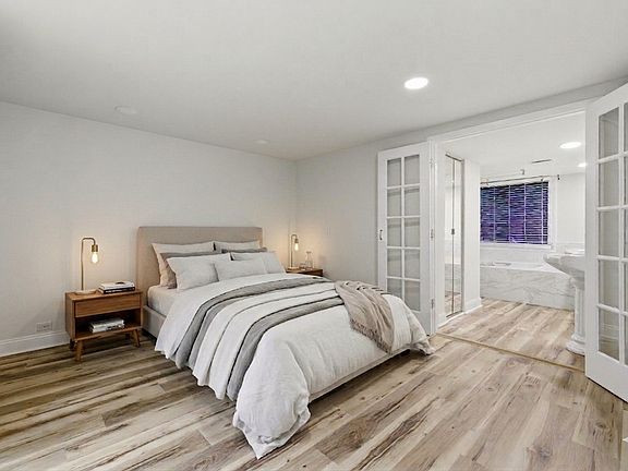 virtually staged primary bedroom with large walk-in closet