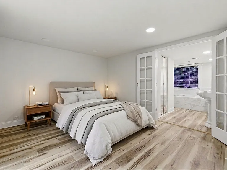 virtually staged primary bedroom with large walk-in closet