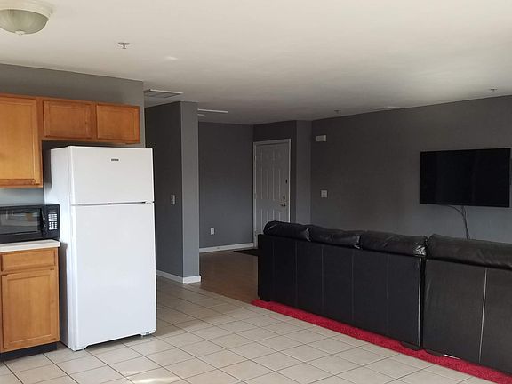 Looking at the living room and entrance from the bay windows.