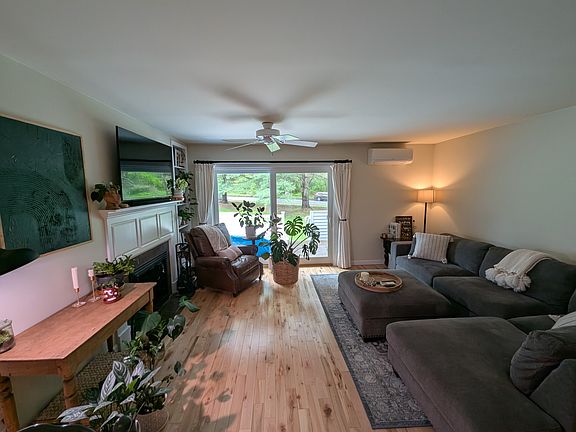 Living room space with sliding glass door to back deck and shared lawn space