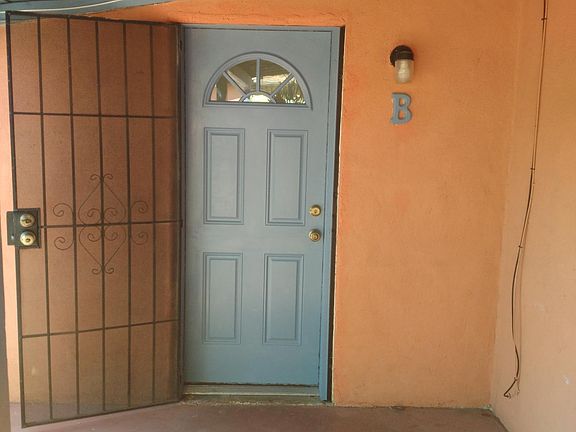 Front door entrance with covered porch and security door