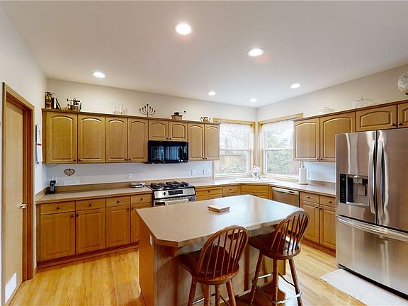 Spacious kitchen with center island, gas range and pantry.