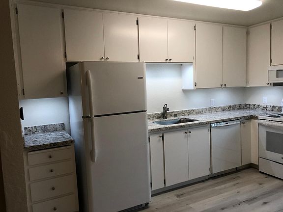 Updated newer kitchen with lots of cabinets and lights, newer: vinyl plank flooring, refrigerator, granite countertops, stainless steel sink, brushed nickel faucet, built in microwave vent combination, oven & range.