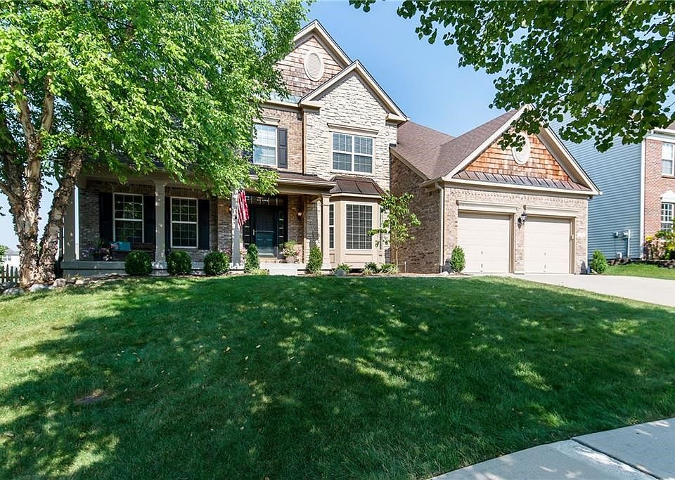 Welcome to this Drees built home! Stone and brick elevation with an inviting "come sit a spell" front porch!