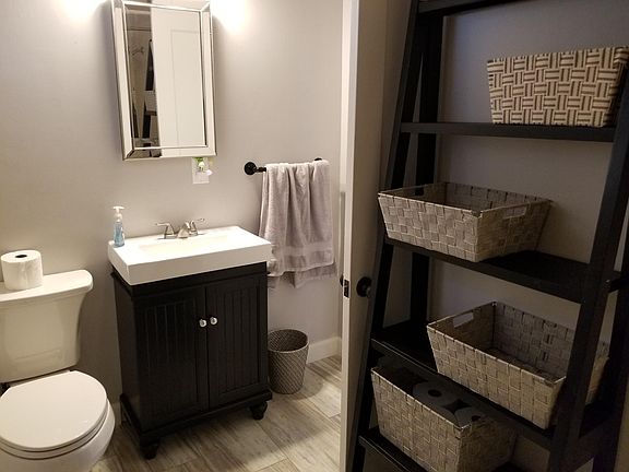Updated bathroom with new sink, toilet, and medicine cabinet.
