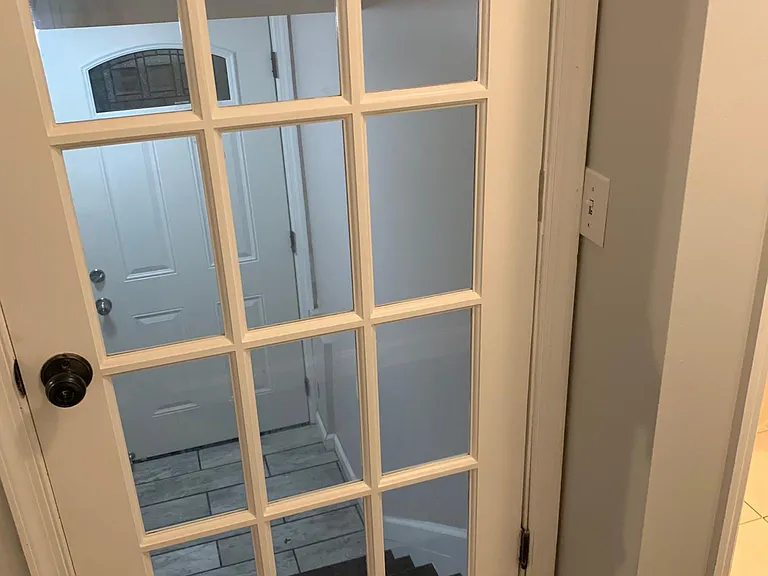 Beautiful French door view down to basement from main floor. Also side door access from side yard.