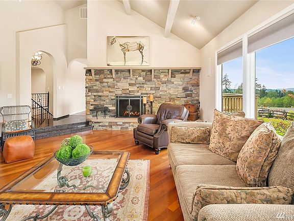 Grand living room with vaulted ceilings and views of the property.