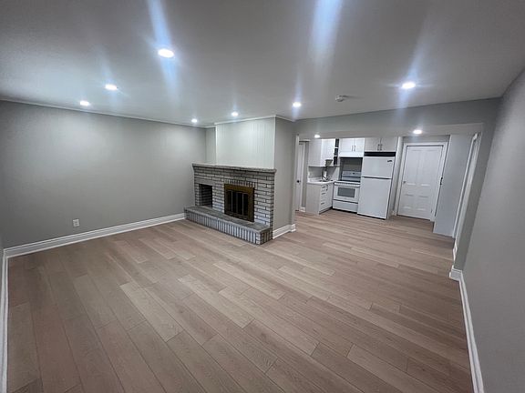 Comfortable family room with large front window and entrance door location.