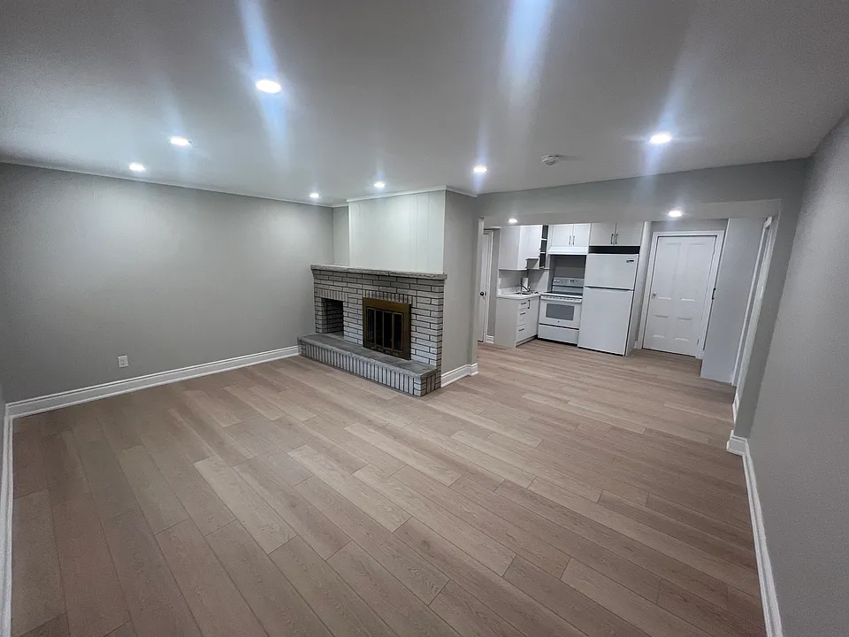 Comfortable family room with large front window and entrance door location.