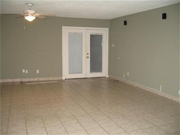 Large Tiled Den- French Doors lead to Garage.