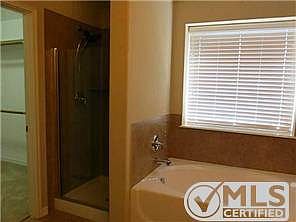 The Master Bath has a separate shower and tub with tile surr