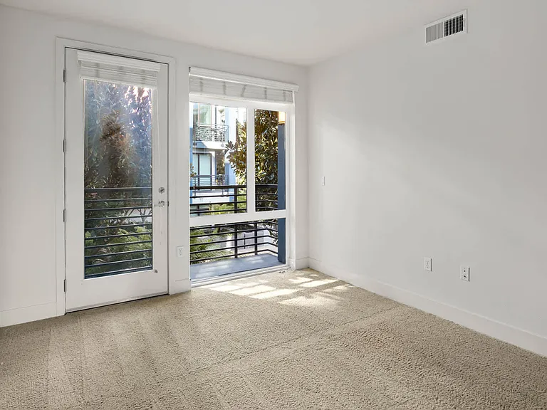 Carpeted Bedroom with Balcony