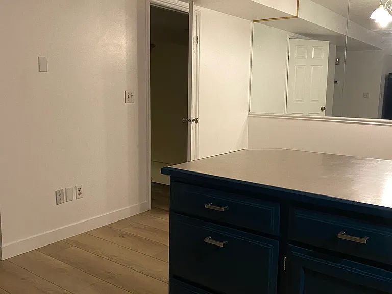 Kitchen bar and door to pantry and stairs going to lower level family/laundry/storage.