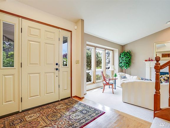 Enter to vaulted ceilings, gleaming hardwood floors and light-filled rooms. 