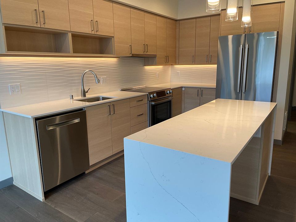 Large kitchen island greatly expands counter space and can double as desk/eating area. Bosch stainless steel appliances. Soft close cabinets.