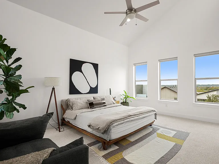 The spacious primary suite features skyline views of downtown, beautiful skylights, and a peaceful retreat filled with natural light