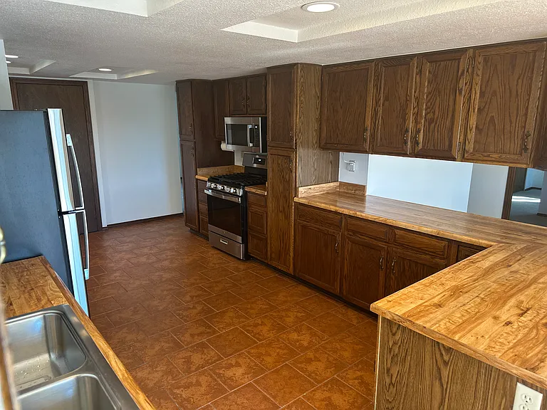Large kitchen with new appliances.