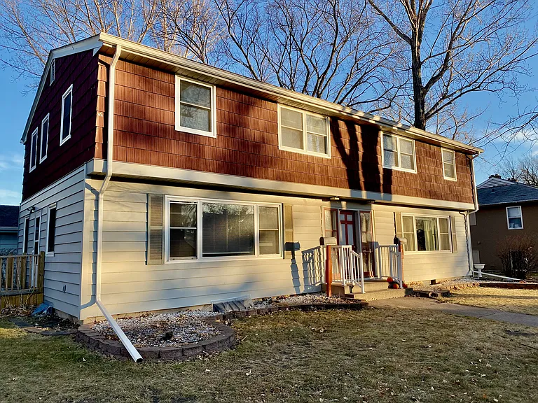 Charming two-story house with warm wooden accents and welcoming front porch, set in a tranquil suburban neighborhood. Charming two-story house with warm wooden accents and welcoming front porch, set in a tranquil suburban neighborhood.