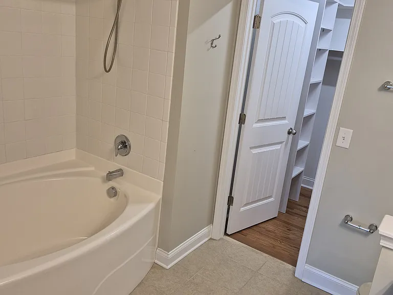 Primary attached bathroom and walk-in closet