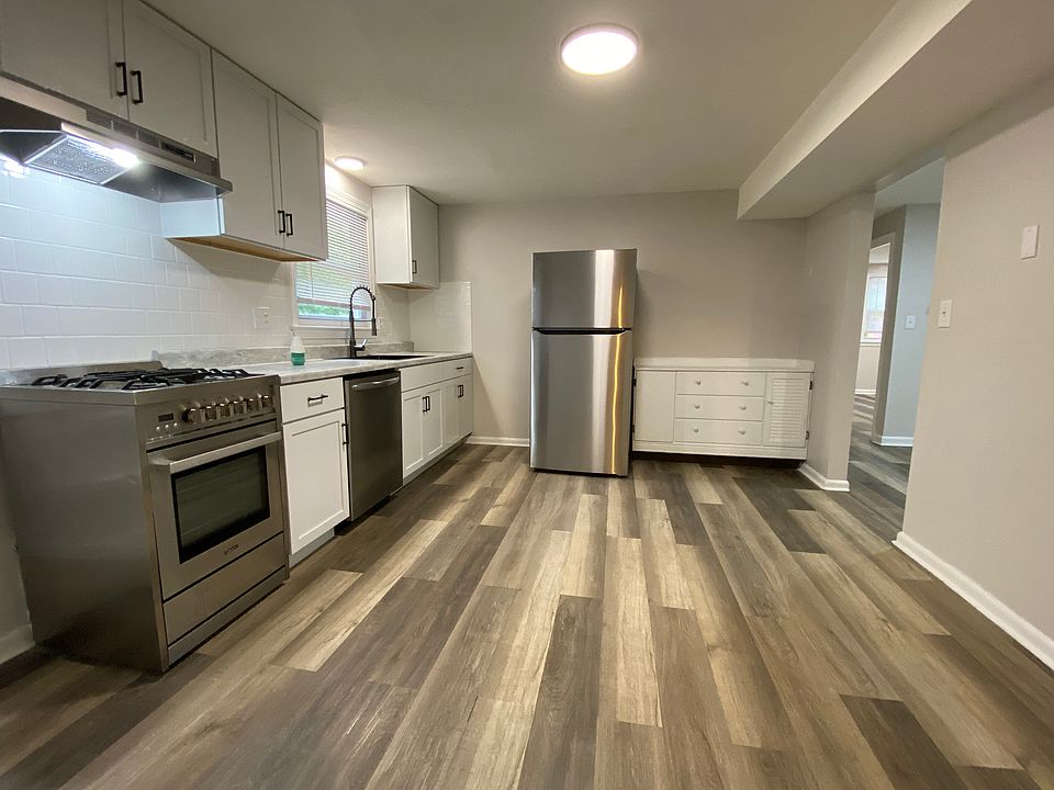 Updated white kitchen with stainless steel appliances