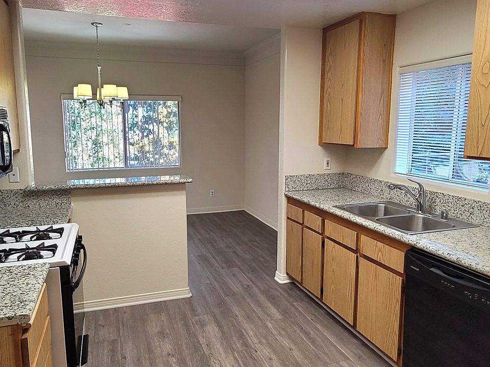 A spacious granite countertop kitchen with a great sunny window, overlooking the full dining room.