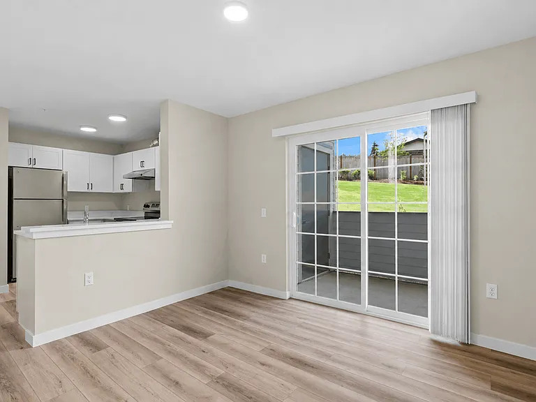 Open-concept apartment dining area with breakfast bar, modern kitchen, luxury vinyl plank flooring, and private patio access. Open-concept apartment dining area with breakfast bar, modern kitchen, luxury vinyl plank flooring, and private patio access.