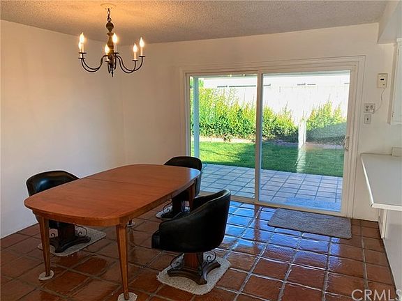 Formal dining room next to kitchen with patio doors to back yard.
