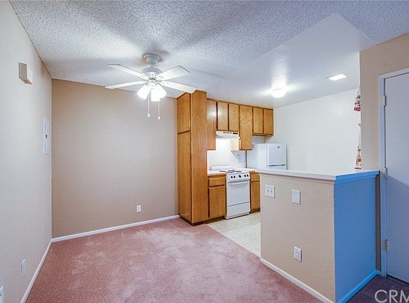 Dining area with new carpet, ceiling fan