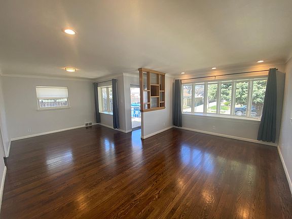 Front entry opens to a dining room and living room with refinished historic hardwood floors