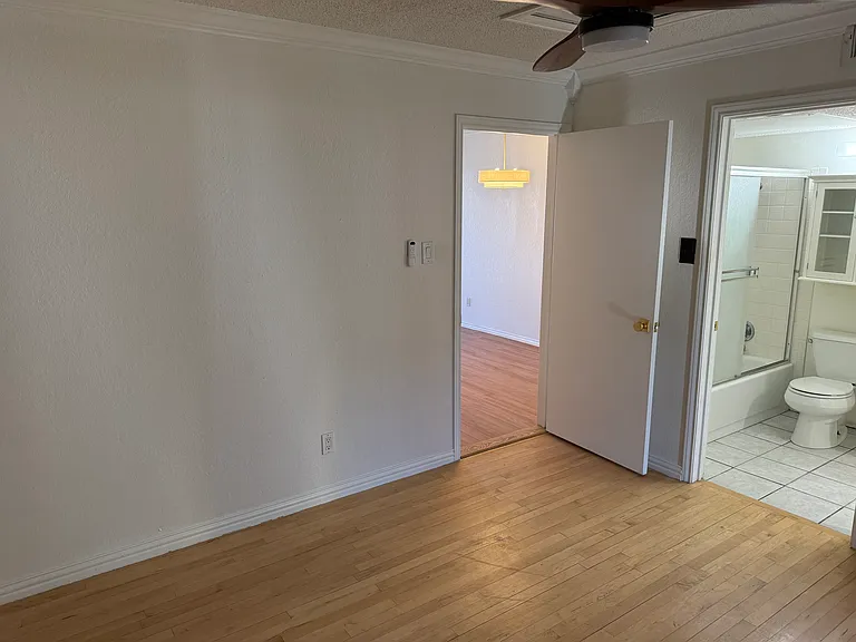 Spacious Bedroom with engineered hardwood floors and full bathroom