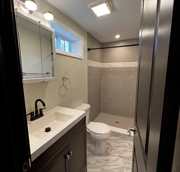 Updated bathroom with stone shower and window.