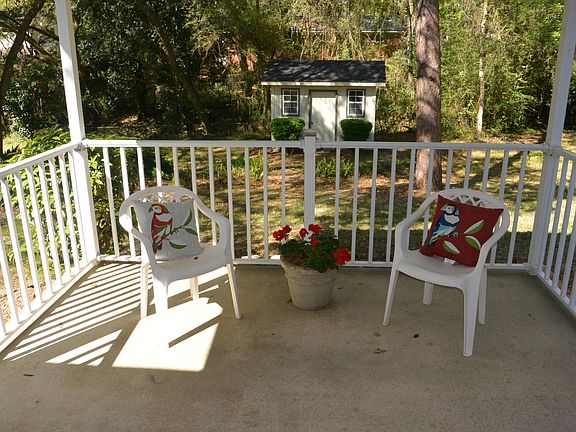 Patio overlooking back yard. Cute shed with electricity. Gas grill on the right of patio. Great entertaining area
