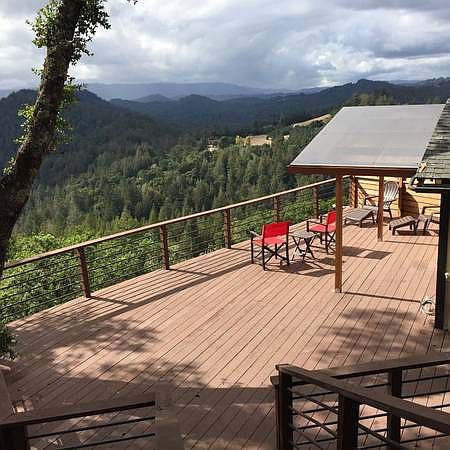 Deck with view taken from steps to parking area.