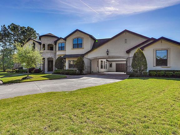 Showstopper at the end of the cul-de-sac! The home sits on over a half an acre. Gated sub-division. Circular driveway and gated motor court with 4 garages.