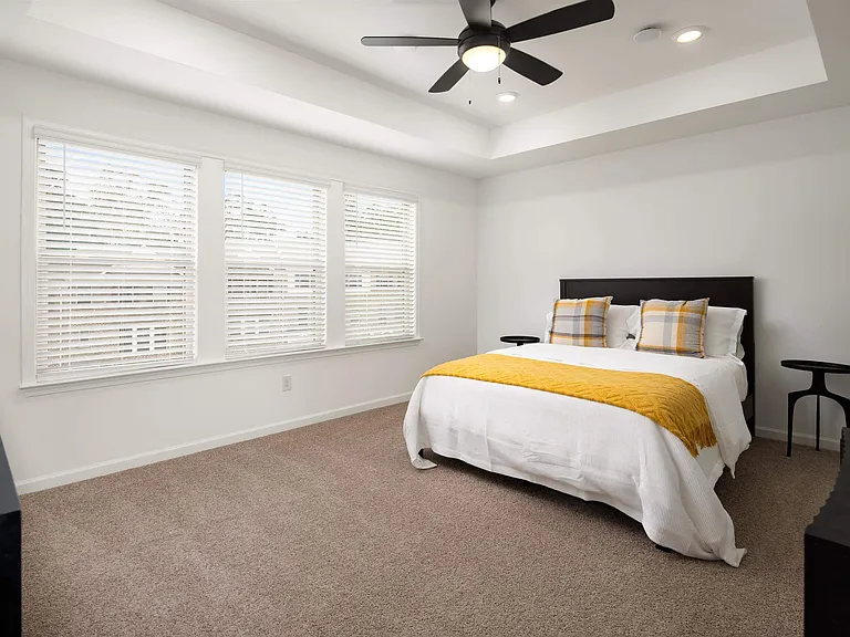 Primary Bedroom with king size bed and large window letting in nice natural light.