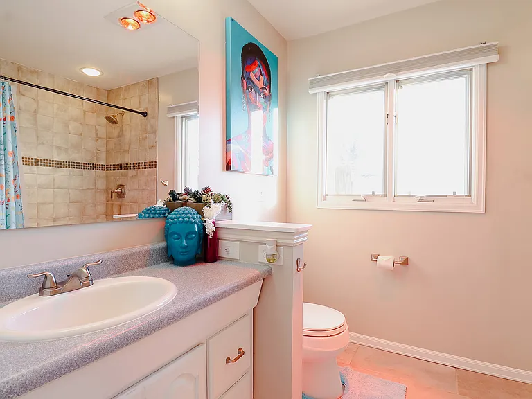 A bathroom dominated by pristine white tones, creating a serene and spacious atmosphere that exudes cleanliness and sophistication.